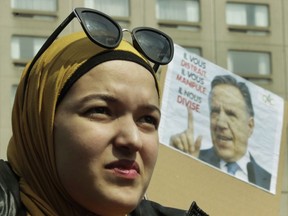 MONTREAL, QUE.:  APRIL 7, 2019 -- A woman listens to speakers at Place Émilie-Gamelin in Montreal Sunday, April 7, 2019 at a demonstration to denounce the Quebec government's Bill 21. The Canadian Collective Anti- Islamophobia (CCAI) called for people to come out to protest the CAQ government's  secularism bill which they say is "... discriminatory and undermines the fundamental rights of religious minorities in Quebec, particularly Muslim women wearing the hijab." (John Kenney / MONTREAL GAZETTE) ORG XMIT: 62358