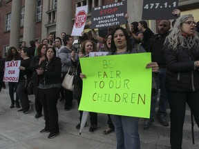 People take part in a protest rally outside the EMSB school board offices in May in a bid to save their schools.