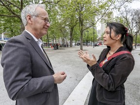 Nakuset, executive director of the Native Women's Shelter of Montreal, speaks with Liberal MNA David Birnbaum, opposition critic for Indigenous affairs, in Cabot Square in May.
