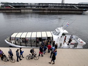 A crowd lines up to board the Old Port to Pointe-aux-Trembles River ferry in the Old Port Montreal on May 28, 2018.