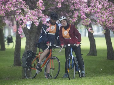 Tour de l'Ile participants Nadine Brennan and Dominic D'Amour shelter themselves from the rain in René-Lévesque Park in Lachine on Sunday June 2, 2019.
