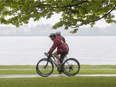 Tour de l'Ile participants make their way in the rain at René-Lévesque Park in Lachine on Sunday June 2, 2019.