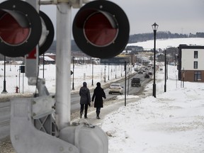 Pedestrians walk along Frontenac St. in Lac-Mégantic on Jan. 20, 2018. The strip, which has only one small apartment building that has been rebuilt, was once the heart of the town before the rail disaster in July 2013.