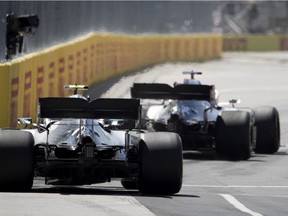 Mercedes driver Lewis Hamilton of Britain leads teammate Valtteri Bottas of Finland out of the pits for a practice session at Circuit Gilles-Villeneuve in 2019.