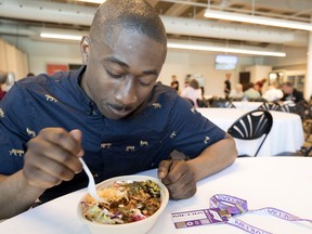 Montreal Gazette reporter Julian McKenzie samples a $14 chicken burrito bowl from a 3 Amigos outlet at Circuit Gilles Villeneuve in Montreal on Friday, June 7, 2019.