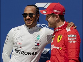 Mercedes driver Lewis Hamilton, left, gives Ferrari counterpart Sebastian Vettel a little hug after Vettel secured the Canadian Grand Prix pole position at Circuit Gilles-Villeneuve in Montreal on Saturday, June 8, 2019.