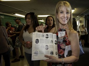 From the class of '89, Laurie Stuart points to her yearbook photo as she and her friends celebrate their high school years during the Riverdale High final good-bye held in Pierrefonds on June 8, 2019. The eduction minister transferred the school to the French public education system, effective as of this fall.