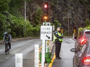 The new Camillien-Houde Rd. was designed to keep cyclists safe and still allow motorists to drive across. Police officers were on hand to alert drivers to the newly installed stop lights on Camillien-Houde Rd. on Friday.