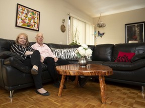 The unique coffee table "is made from an elm tree that was chopped down in 1971. It was my father’s and the inscription is written underneath," explains Julia Pyves seated with Tommy Green in their Nun's Island townhouse.