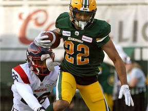 Eskimos' Jordan Robinson eludes a tackle from Alouettes' Greg Reid during season debut for both teams Friday night in Edmonton.