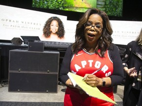 MONTREAL, QUE:  Oprah Winfrey signs her book prior to her show at the Bell Centre in Montreal, Quebec June 16, 2019.