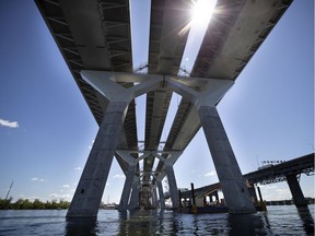 The sun pokes through the three different deck surfaces as seen for the water level during a media tour of the new Champlain Bridge in Montreal on Monday, June 17, 2019.