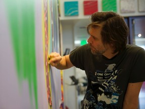 Jim Carrey at work in his studio: The exhibit This Light Never Goes Out: Political Cartoons by Jim Carrey runs from June 20 to Sept. 1 at the Phi Centre in Old Montreal.