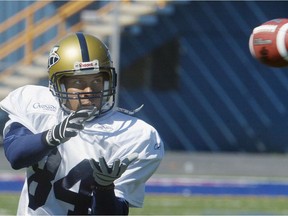 Blue Bombers wide receiver Robert Gordon hauls in a pass during practice in June 2004. Credit: Brian Donogh/Winnipeg Sun