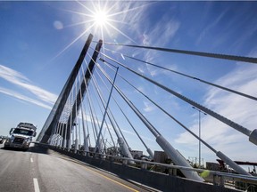 A truck passes next to the super-structure of the new Samuel de Champlain Bridge from the South Shore toward Montreal hours after it was opened to traffic on Monday, June 24, 2019.