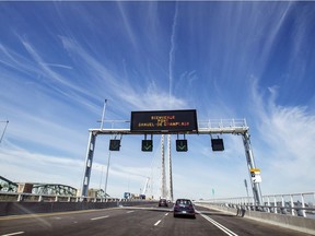 Cars cross over the new Samuel De Champlain Bridge from the South Shore toward Montreal hours after it was opened to traffic in on Monday, June 24, 2019.  The super-structure of the old Champlain Bridge is at left.