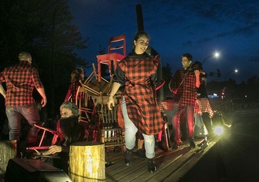 A woman dances as part of a tableaux with a lumberjack theme during the Fête Nationale parade on St. Denis St. in Montreal  on Monday, June 24, 2019.