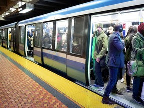 A man tries to squeeze in to a crowded metro car on the STM Orange Line in May 2019.