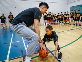 Kayden Robert, age 7, steals the ball in a one-on-one drill with Toronto Raptors shooting guard Danny Green during Day 2 of Green's basketball camp at École Lucien-Pagé, in the Parc-Extension borough, on Thursday, June 27, 2019.