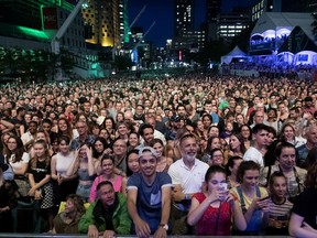 June 27, 2019 -- A large crowd waits for Charlotte Cardin to perform the opening concert of the Montreal International Jazz Festival in Montreal, on Thursday, June 27, 2019.