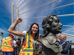 Worker Catherine Desautels posed with the newly unveiled bust of Samuel de Champlain at the inauguration of the Samuel De Champlain Bridge on Friday.