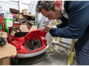 Simon Berman, co-owner of Montreal Mini-Storage, checks out a child’s electric car in one of the unclaimed storage lockers at his Beaumont Ave. facility.