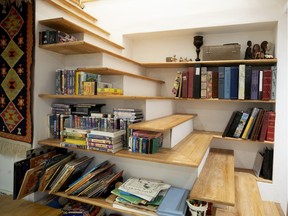Bookshelves have been built in to the basement stairs in the home of Sandy and Paul Gauthier in N.D.G.