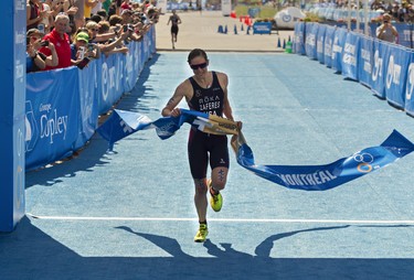 MONTREAL, QUE.: JUNE 29, 2019 -- Women ITU World Triathlon Series   standings leader Katie Zaferes crosses the finish line to win the Montreal International Triathlon in the Old Montreal area of Montreal Friday, June 28, 2019 11 seconds ahead of Georgia Taylor-Brown (background). Zaferes finished the 750-metre swim, 20-kilometre cycle and five-kilometre run in 58 minutes 15 seconds for her fourth victory of the season. (background).  (John Kenney / MONTREAL GAZETTE) ORG XMIT: 62767