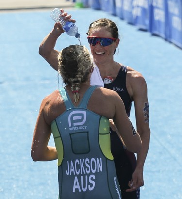 MONTREAL, QUE.: JUNE 29, 2019 -- Women ITU World Triathlon Series   standings leader Katie Zaferes and winner of the Montreal International Triathlon pours water on fellow competitor Emma Jackson at the end of the race in the Old Montreal area of Montreal Friday, June 28, 2019. Zaferes finished the 750-metre swim, 20-kilometre cycle and five-kilometre run in 58 minutes 15 seconds for her fourth victory of the season. (John Kenney / MONTREAL GAZETTE) ORG XMIT: 62767
