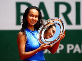 Leylah Annie Fernandez of Canada celebrates victory with the trophy during the girls juniors singles final against Emma Navarro of The United States during Day fourteen of the 2019 French Open at Roland Garros on June 08, 2019 in Paris, France.
