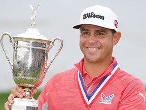 Gary Woodland of the United States poses with the trophy after winning the 2019 U.S. Open at Pebble Beach Golf Links on Sunday, June 16, 2019.