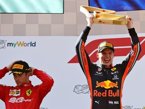 Race winner Max Verstappen of Netherlands and Red Bull Racing celebrates on the podium as second placed Charles Leclerc of Monaco and Ferrari looks dejected during the F1 Grand Prix of Austria at Red Bull Ring on June 30, 2019 in Spielberg, Austria.