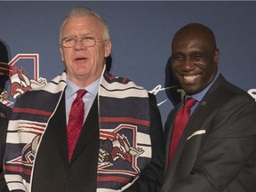 Former Alouettes head coach Mike Sherman, left, says he was surprised that general manager Kavis Reed found fault with his work in assembling his team and installing a game plan.