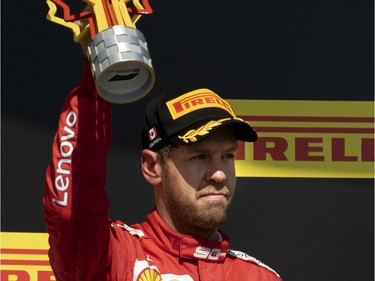 MONTREAL, QUE.: June 9, 2019 -- Scuderia Ferrari Mission Winnow driver Sebastian Vettel (5) of Germany holds up the second place trophy during the Canadian Grand Prix at the Circuit Gilles Villeneuve in Montreal, on Sunday, June 9, 2019.