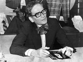 Designer Pierre Cardin was sporting a striped shirt and plaid butterfly bow tie as he talked to reporters at a showing of his fashions in Montreal in June 1974.