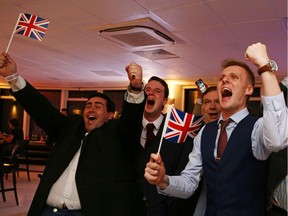 Leave.EU supporters wave Union flags and cheer as the results come in at the Leave.EU referendum party at Millbank Tower in central London early in the morning of June 24, 2016.