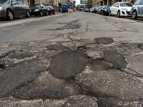 Potholes are rite of spring in Montreal and it was no different on William Street between Guy and Notre-Dame Streets on Friday April 6, 2018.