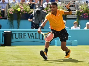 Montreal's Felix Auger Aliassime returns to Greece's Stefanos Tsitsipas during their men's singles quarter final tennis match at the ATP Fever-Tree Championships tournament at Queen's Club in west London on June 21, 2019.