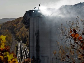 Smoke continues to rise from the damaged Bartlett Grain Company elevator in Atchison, Kan. Monday, Oct. 31, 2011. Six people were killed after a grain dust explosion rocked the facility.