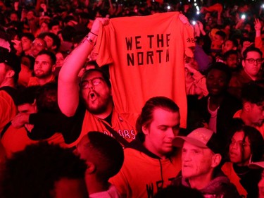 Fans celebrate their win in Game 6 of the NBA basketball Finals between the Toronto Raptors and the Golden State Warriors on a large screen in a fan zone in Montreal, Quebec, Canada, June 13, 2019.  REUTERS/Christinne Muschi      TPX IMAGES OF THE DAY