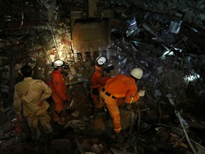 A rescue team attempts to find the missing workers at a collapsed building in Sihanoukville, Cambodia, June 22, 2019.