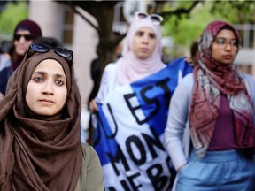 Women protest Quebec's new Bill 21, which will ban teachers, police, government lawyers and others in positions of authority from wearing religious symbols such as Muslim head coverings and Sikh turbans, in Montreal, Quebec, Canada, June 17, 2019.  REUTERS/Christinne Muschi