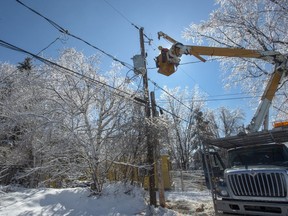 Hydro Quebec workers repair power lines in Laval, Que., on April 10, 2019 after an ice storm hit the area. The ice storm that plunged hundreds of thousands of Hydro-Quebec customers into darkness in April cost the provincial utility about $14 million, according to data it provided to