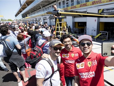 Fans take selfies in the pit during the annual Grand Prix open house at Circuit Gilles Villeneuve  in Montreal on Thursday, June 6, 2019.