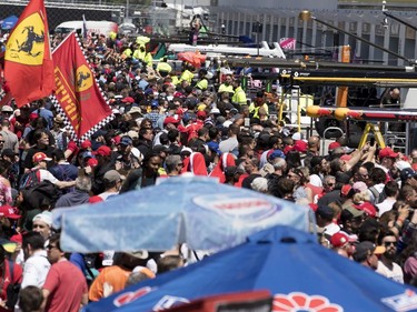 Fans fill the pit lane during the annual Grand Prix open house at Circuit Gilles Villeneuve  in Montreal on Thursday, June 6, 2019.