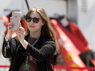 Lyndsey Welch  of Calgary takes a selfie with Ferrari car parts during the annual Grand Prix open house at Circuit Gilles Villeneuve  in Montreal on Thursday, June 6, 2019.