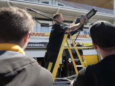 Fans watch closely as mechanics set up the Renault driver Nico Hulkenberg (27) of Germany garage during annual open house at Circuit Gilles Villeneuve  in Montreal on Thursday, June 6, 2019.