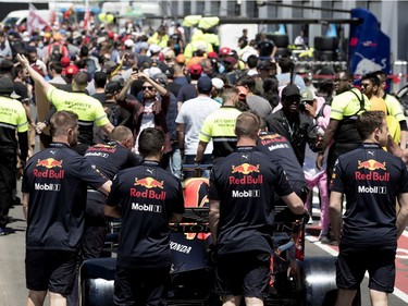 Red Bull mechanics are stuck in traffic as fans are cleared from the pit lane after the annual Grand Prix open house at Circuit Gilles Villeneuve  in Montreal on Thursday, June 6, 2019. The Red Bull team members were trying to get to the technical inspection team.