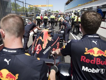 Red Bull mechanics are stuck in traffic as fans are cleared from the pit lane after the Grand Prix open house at Circuit Gilles Villeneuve  in Montreal on Thursday, June 6, 2019. The Red Bull team members were trying to get to the technical inspection team.