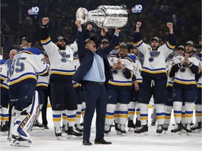 St. Louis Blues head coach Craig Berube hoists the Stanley Cup after beating the Bruins 4-1 in Game 7 of the final on June 12, 2019 at TD Garden in Boston.